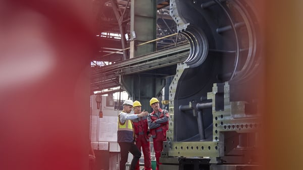 3 work men discuss project at Quarterly Business Reviews (QBRs)