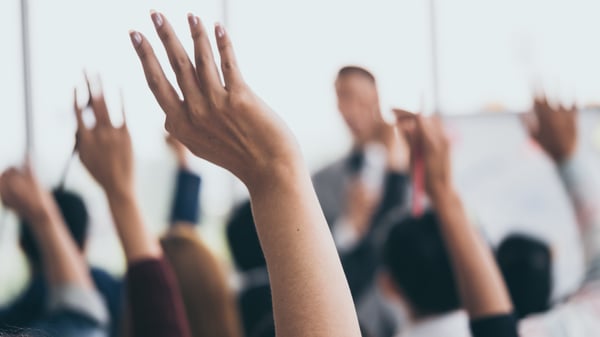 Clients are surveyed with hands up during Quarterly Business Reviews (QBRs)