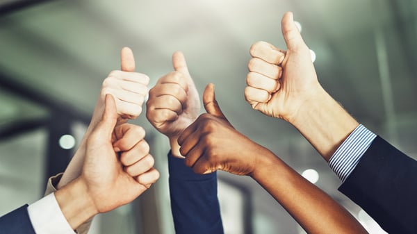 Business people have thumbs up showing they are advocates after Quarterly Business Reviews (QBRs)