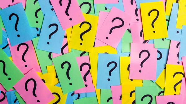 Post-it-notes with question marks symbolising having questions about quarterly business revews QBRs