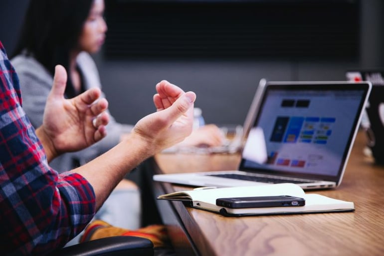 Mans hands gesture during Quarterly Business Reviews (QBRs)